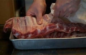 Removing silver skin membrane from spare ribs.