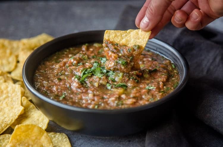 Dipping into a bowl of homemade salsa
