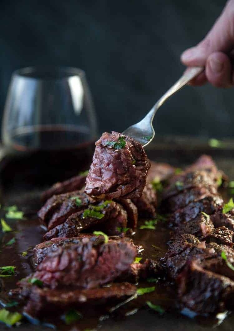A slice of meat on a fork.