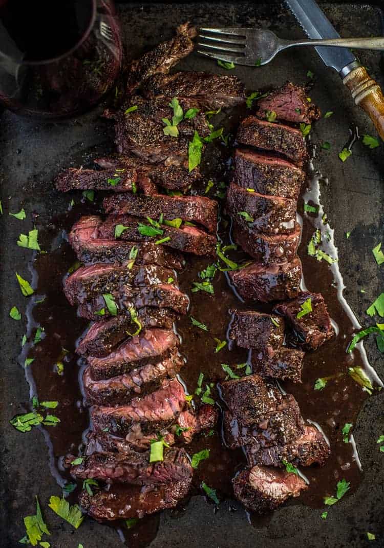 Slices of Grilled Hanger Steak with Red Wine Sauce on a platter.