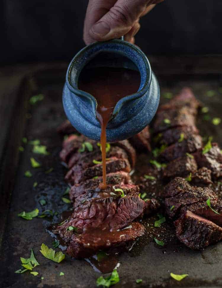 Red Wine Sauce being poured over a Grilled Hanger Steak