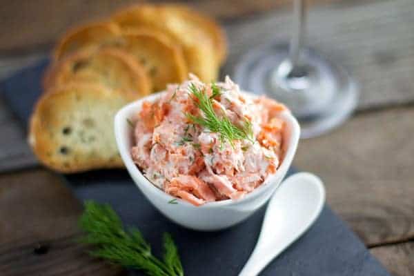 Smoked Salmon Dip with crostini in a cup.