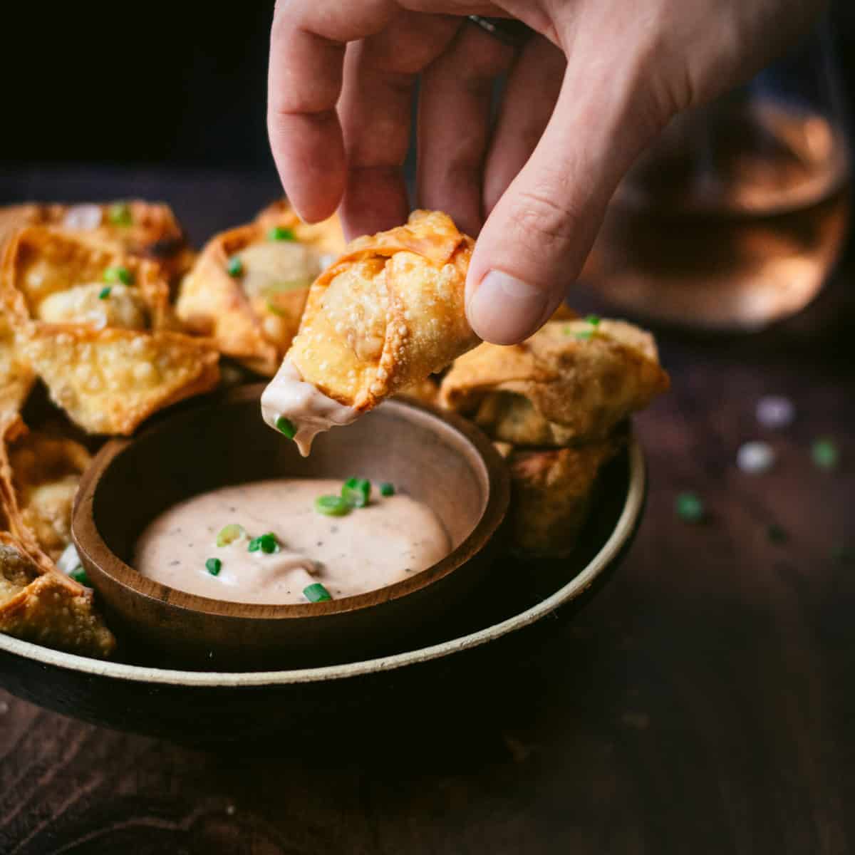 dipping a pulled pork wonton