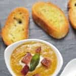 Smoked butternut squash soup recipe topped with smoked bacon and fried sage, pinterest text over top