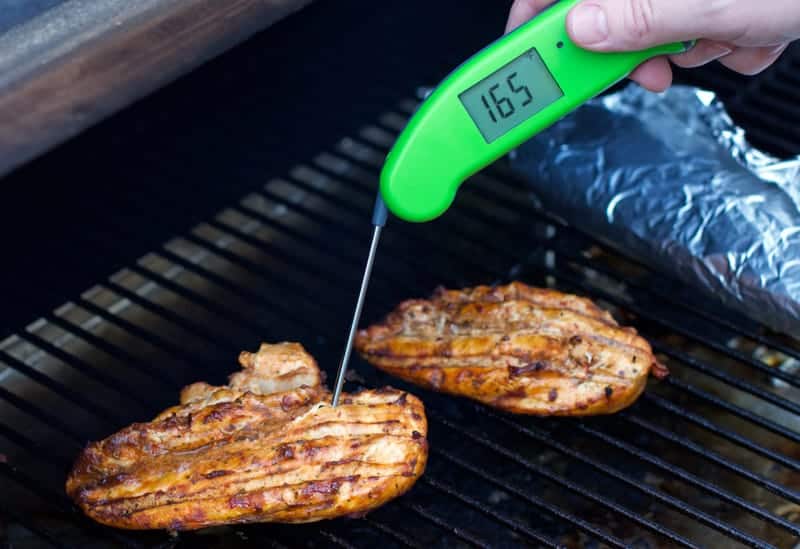 An MK4 Thermapen taking temperature of grilled chicken at 165 degrees internal temperature.