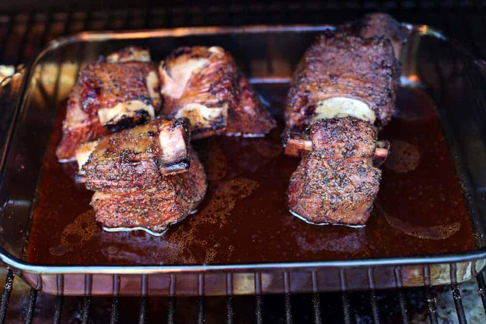 Beef Short Ribs Braising in a glass dish