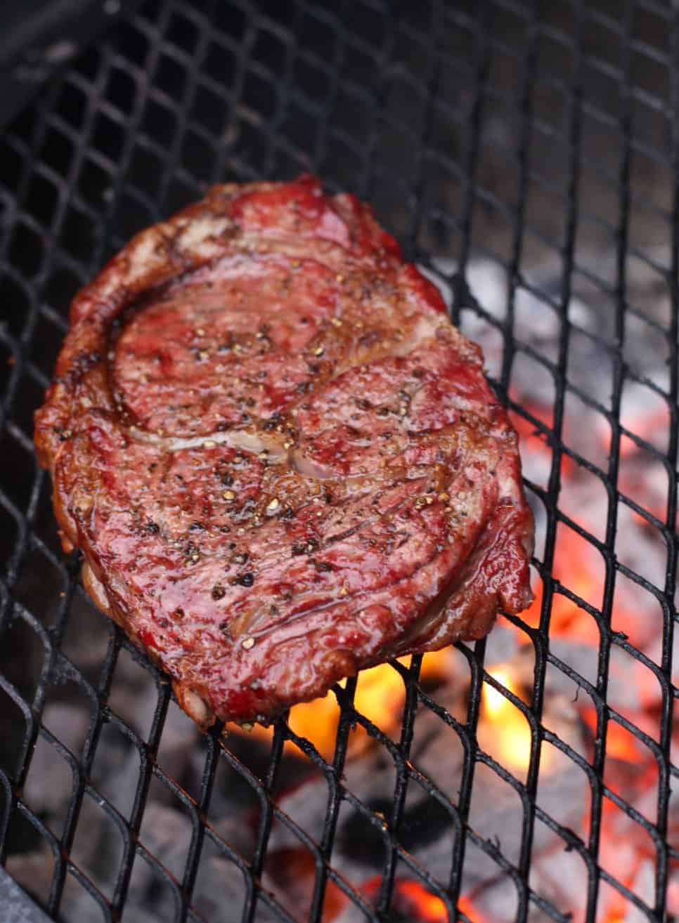 Reverse Seared Ribeye Steak cooking on a hot grill
