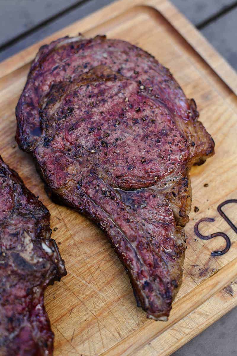 Reverse Seared Smoked Ribeye Steak resting on a cutting board