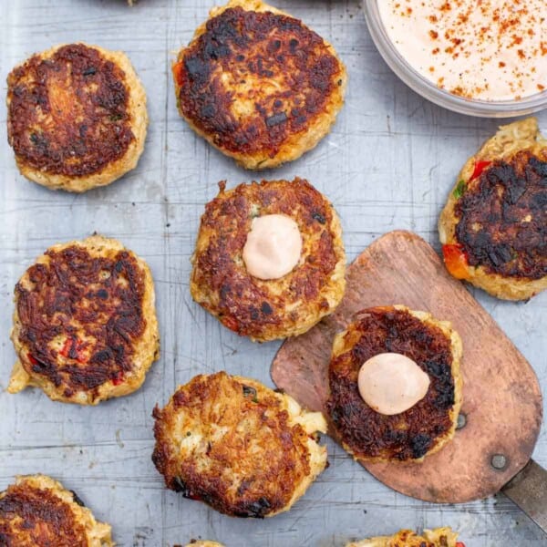 Grilled crab and salmon cakes with dipping sauce.