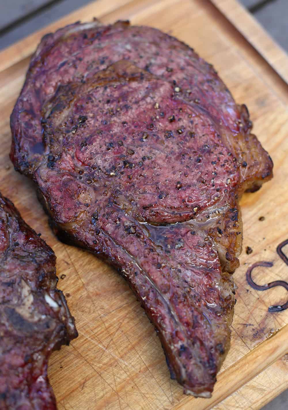 Reverse Sear Ribeye Steak resting on a cutting board