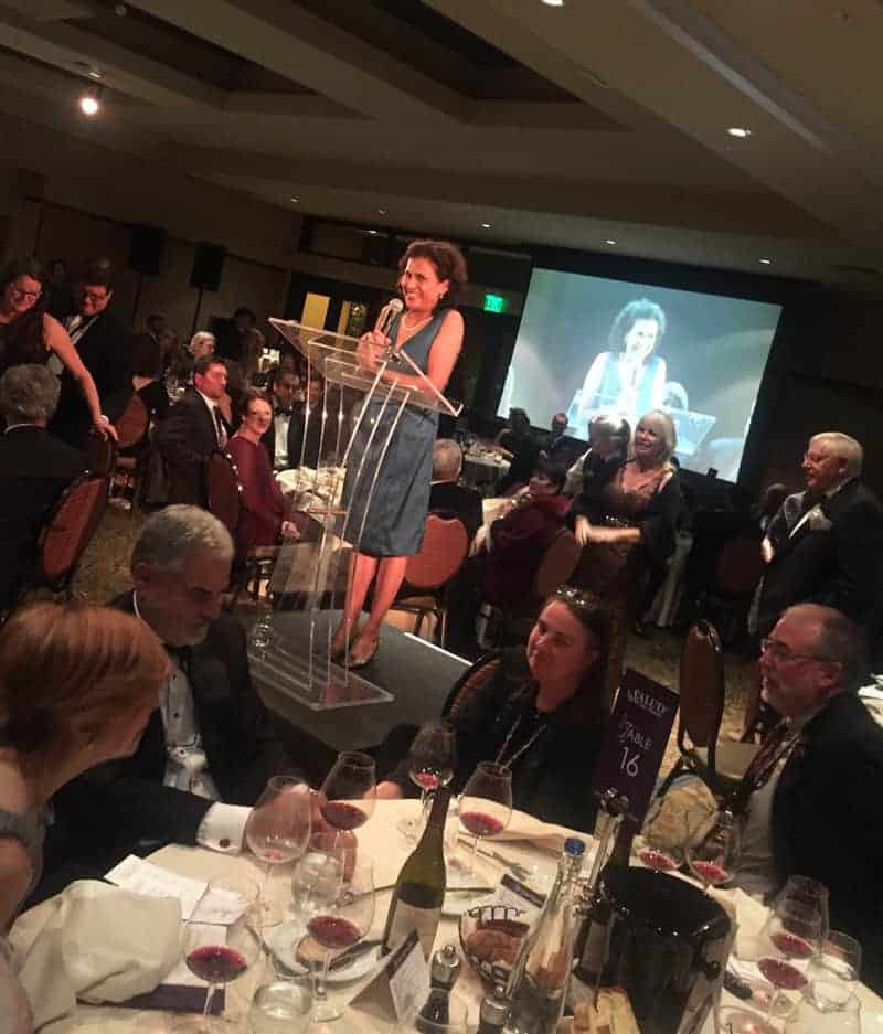 Leda Garside speaking at 2015 ¡Salud! Auction