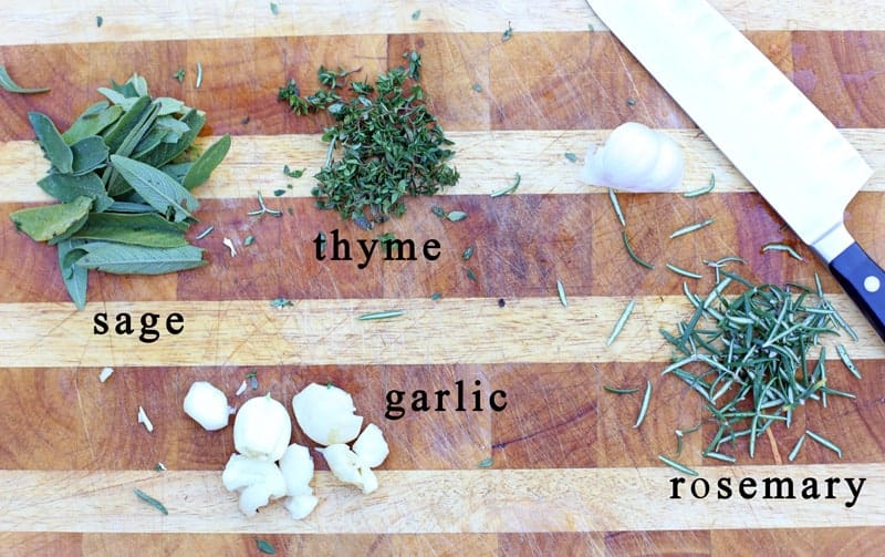 Ingredients for an herb paste on a cutting board.