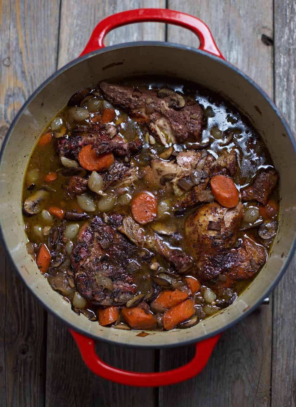 A cast iron pot filled with smoked Coq au Vin