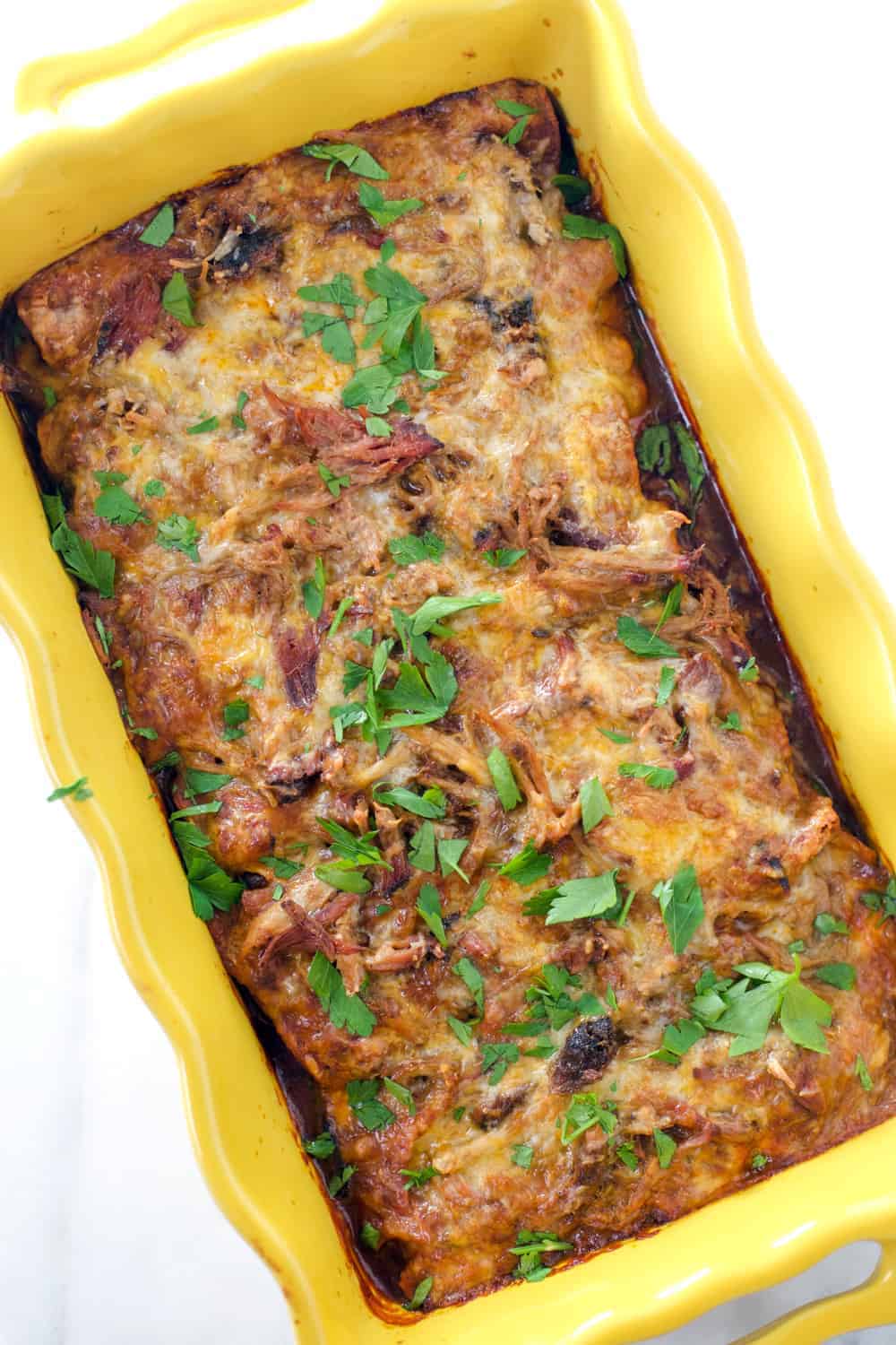 Pulled Pork Enchiladas in a yellow pan