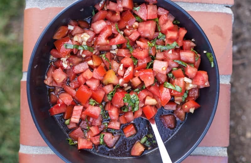 A bowl of tomatoes, basil, and balsamic