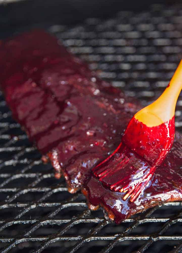 Applying Blueberry Bourbon Rosemary BBQ Sauce to Smoked Ribs