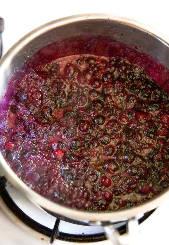 blueberry bourbon bbq sauce simmering in a pot