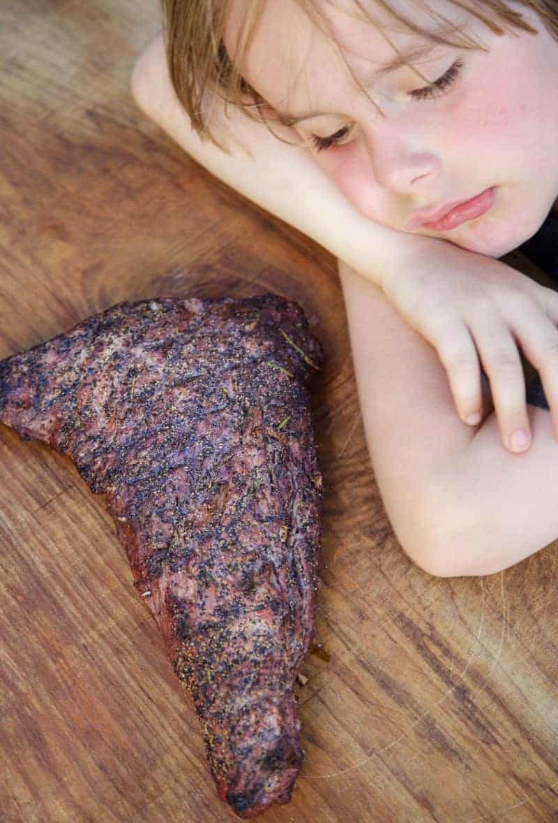 Beef resting on a wood cutting board