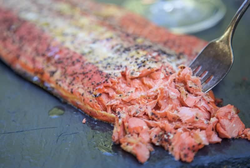 smoked salmon being flaked with a fork