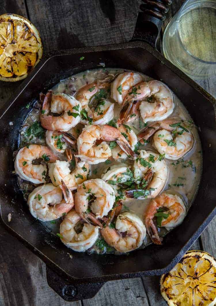 Grilled Shrimp with Garlic White Wine Butter Sauce cooked in a cast iron pan on the grill