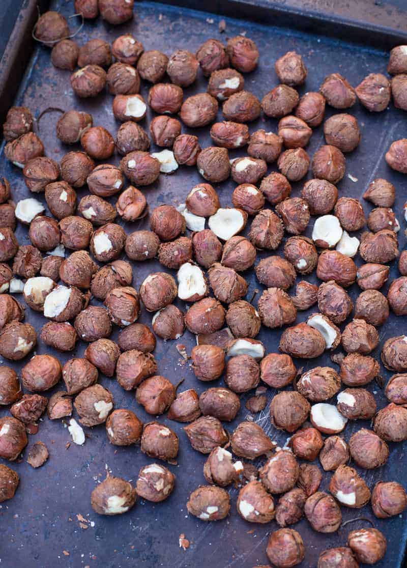 Raw hazelnuts on a sheet tray