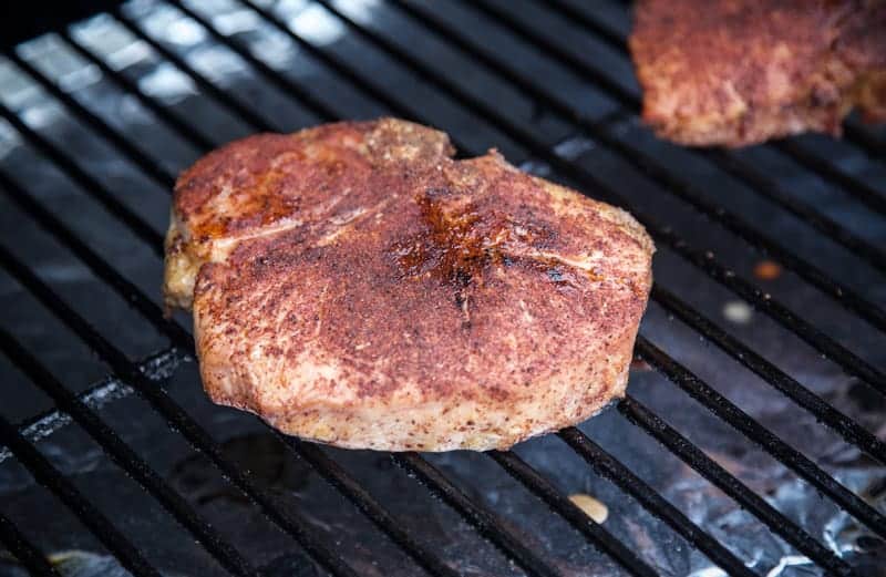 Pork chop cooking on a smoker