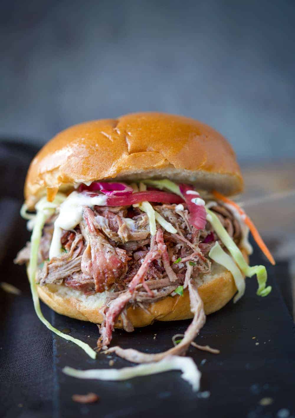 Smoked Pulled Lamb Sliders topped with slaw