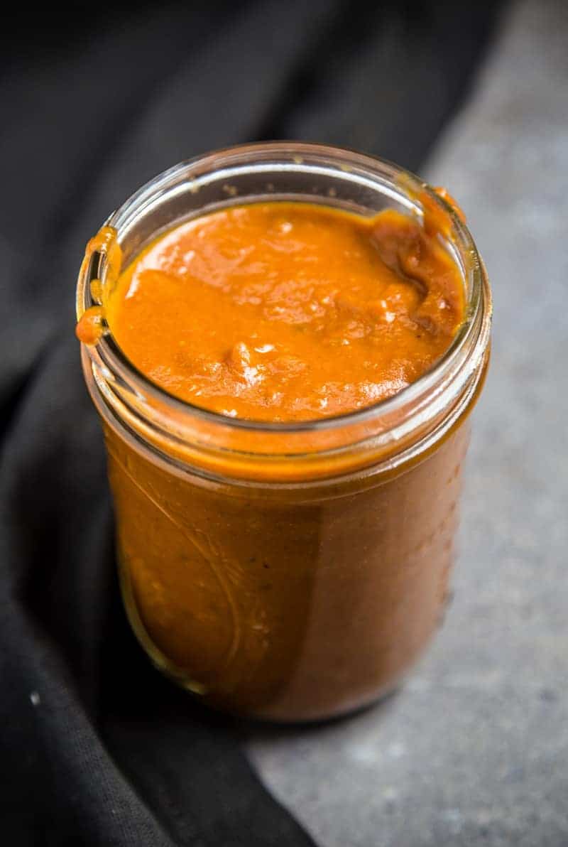 A mason jar full of no sugar added Mango BBQ Sauce
