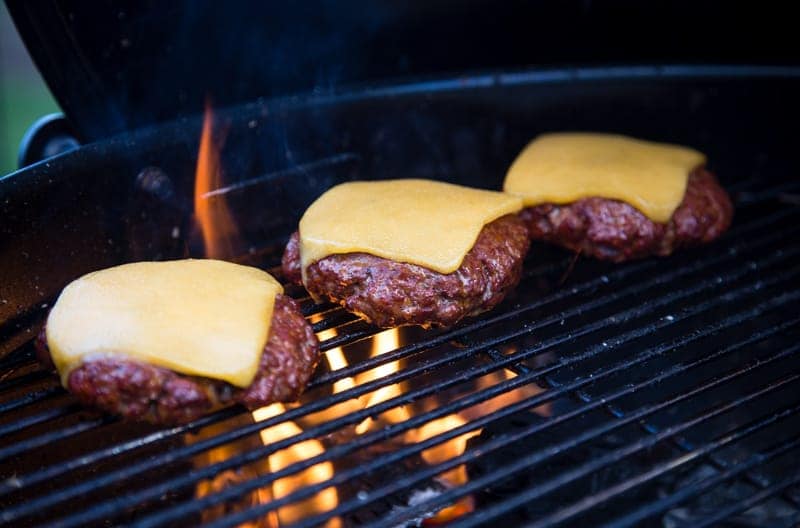 Grilling Three Cheeseburgers on a Grill