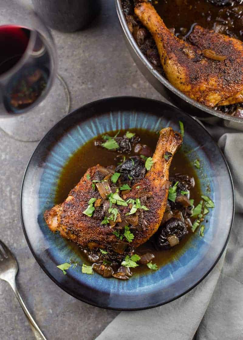 Ancho grilled chicken with a rich ancho chile prune sauce in a plate.