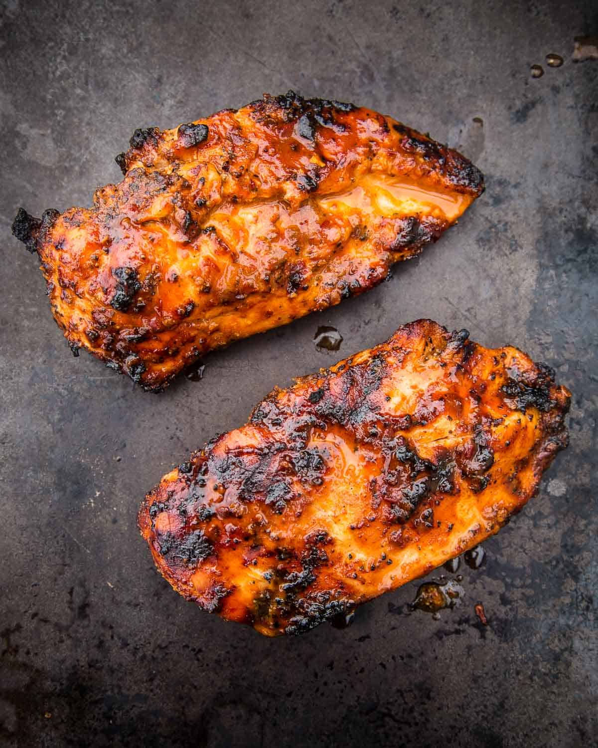 Chipotle Marinated Grilled Chicken Breasts resting on a sheetpan