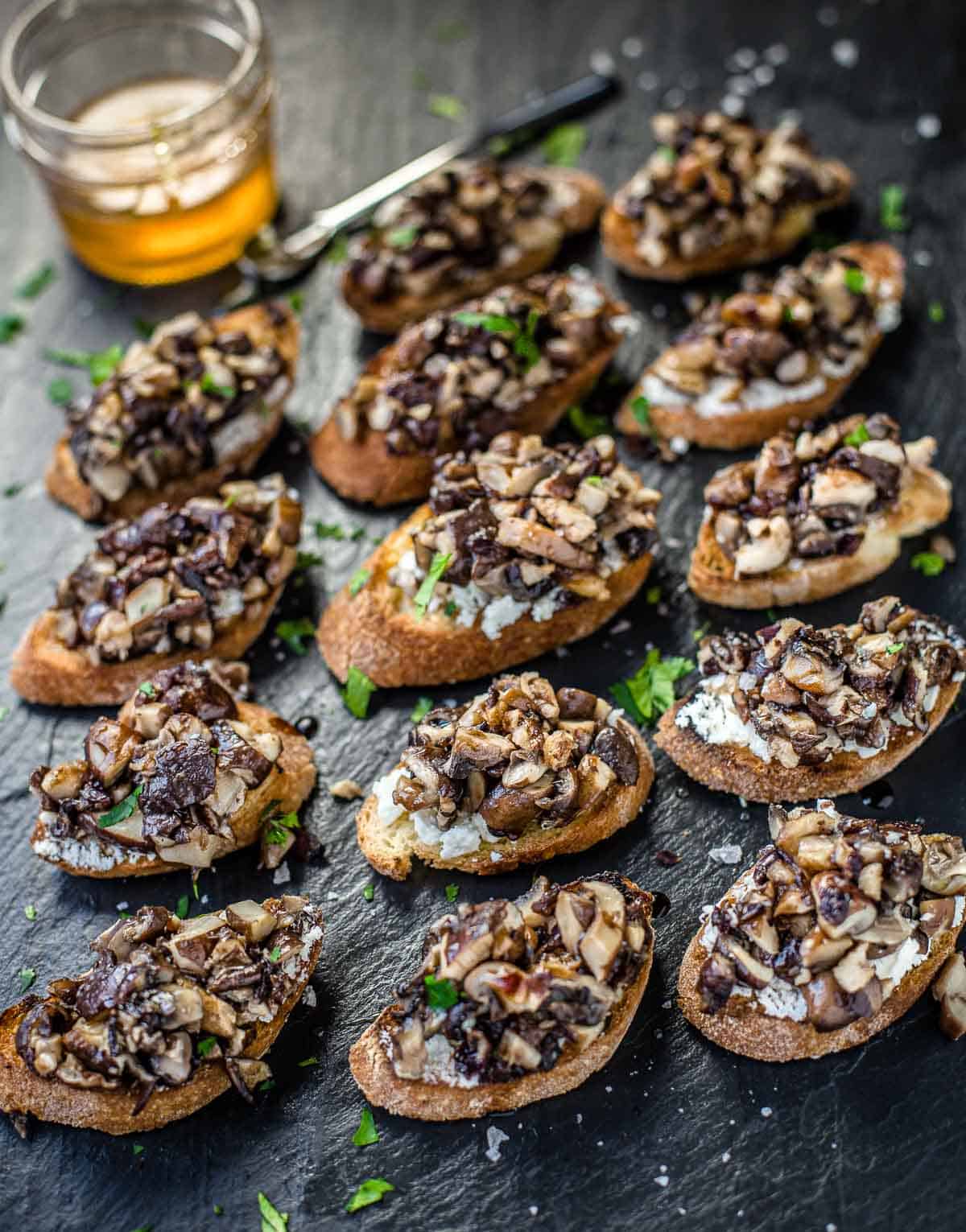 Grilled Mushroom Crostini on a platter with Smoked Honey and Aged Balsamic.