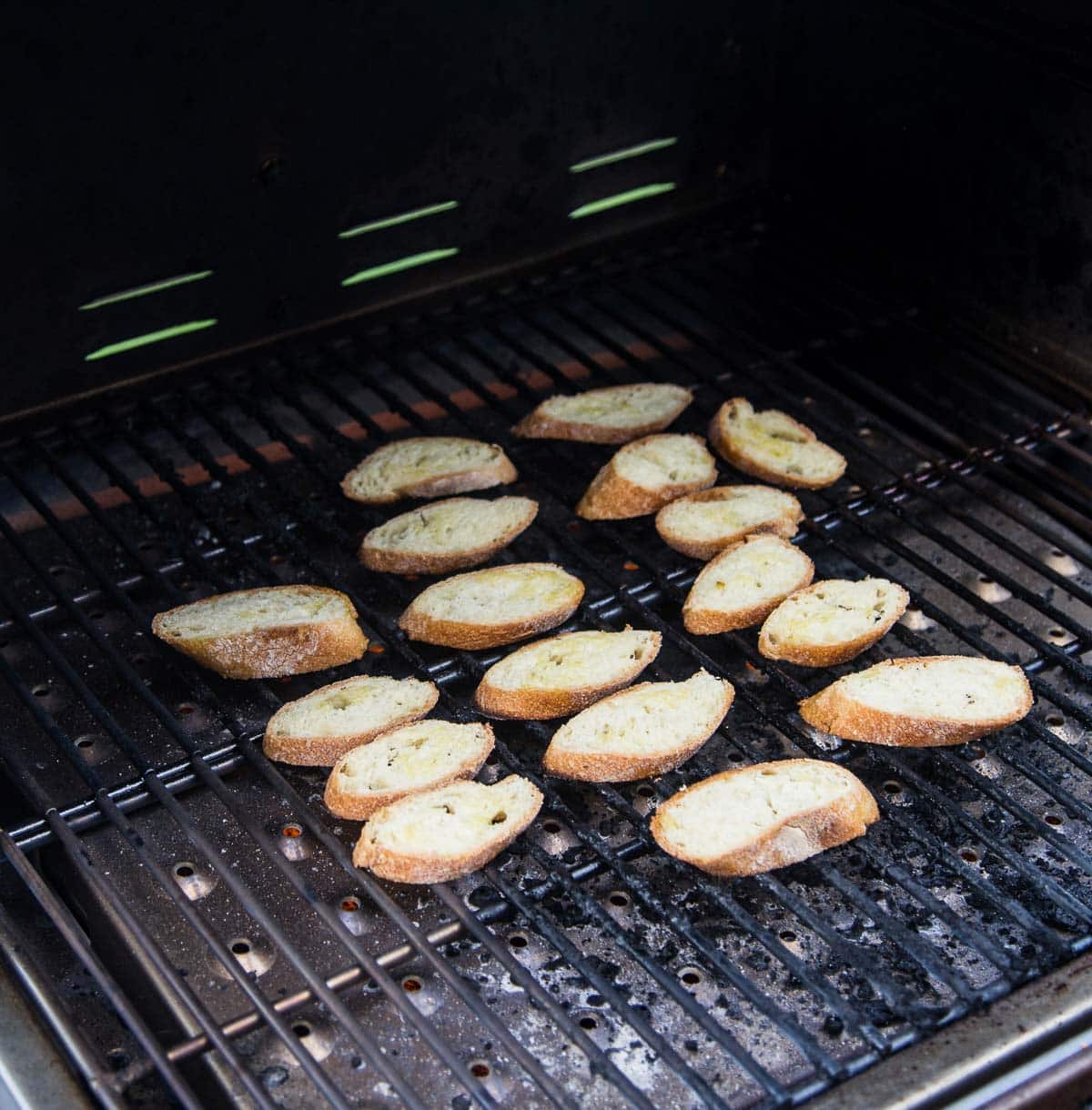 Toasting crostini on a grill.