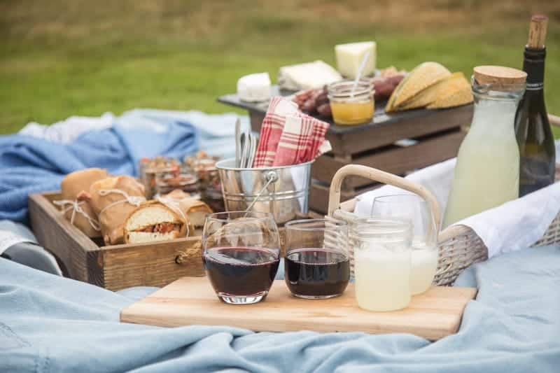 Picnic platter with Beaujolais Wine, Smoked Pork Tenderloin Sandwiches, and Lentil Salad