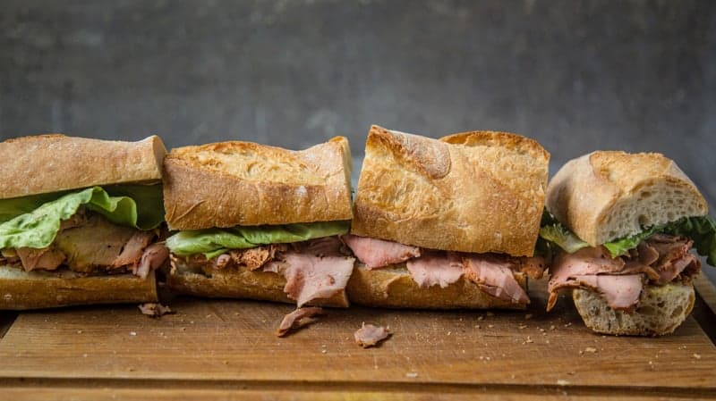 Smoked Pork Tenderloin Sandwiches on a cutting board.