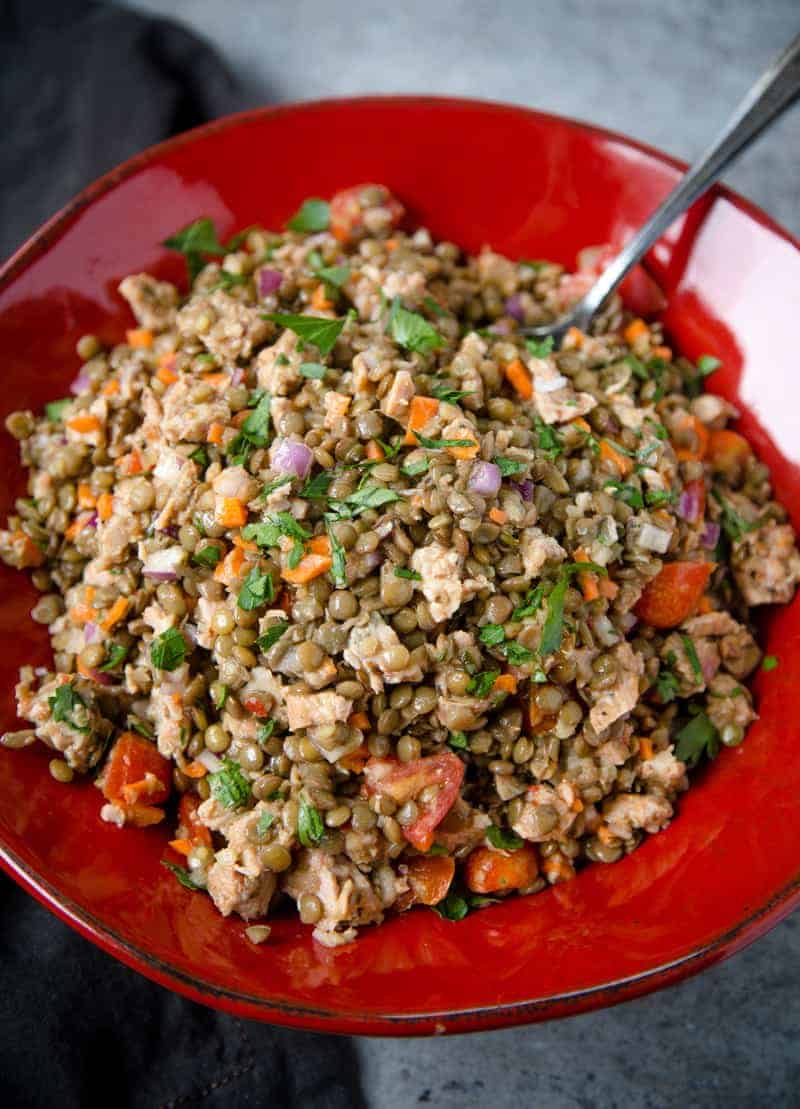 Cold Lentil Salad with Smoked Sausage in a red bowl