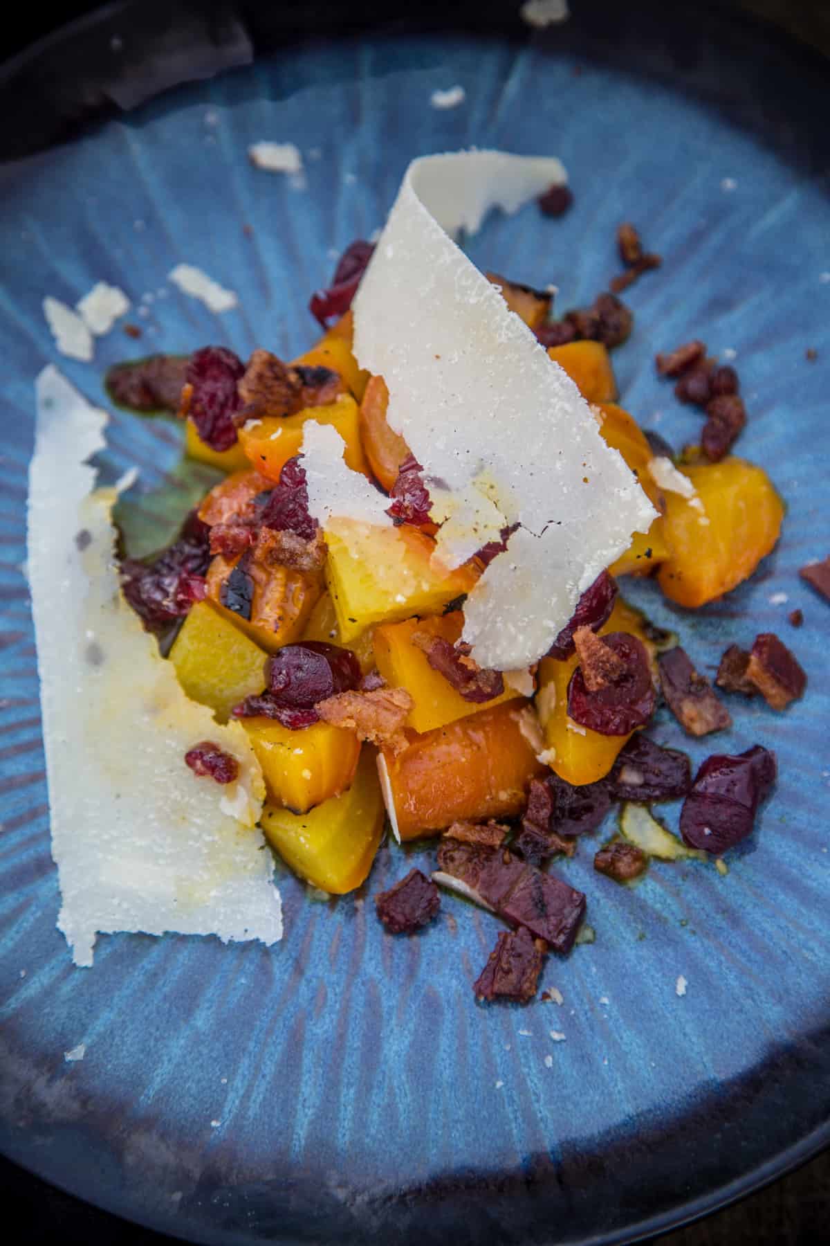 Grilled Beet Salad with Rose Infused Cranberries on a blue plate