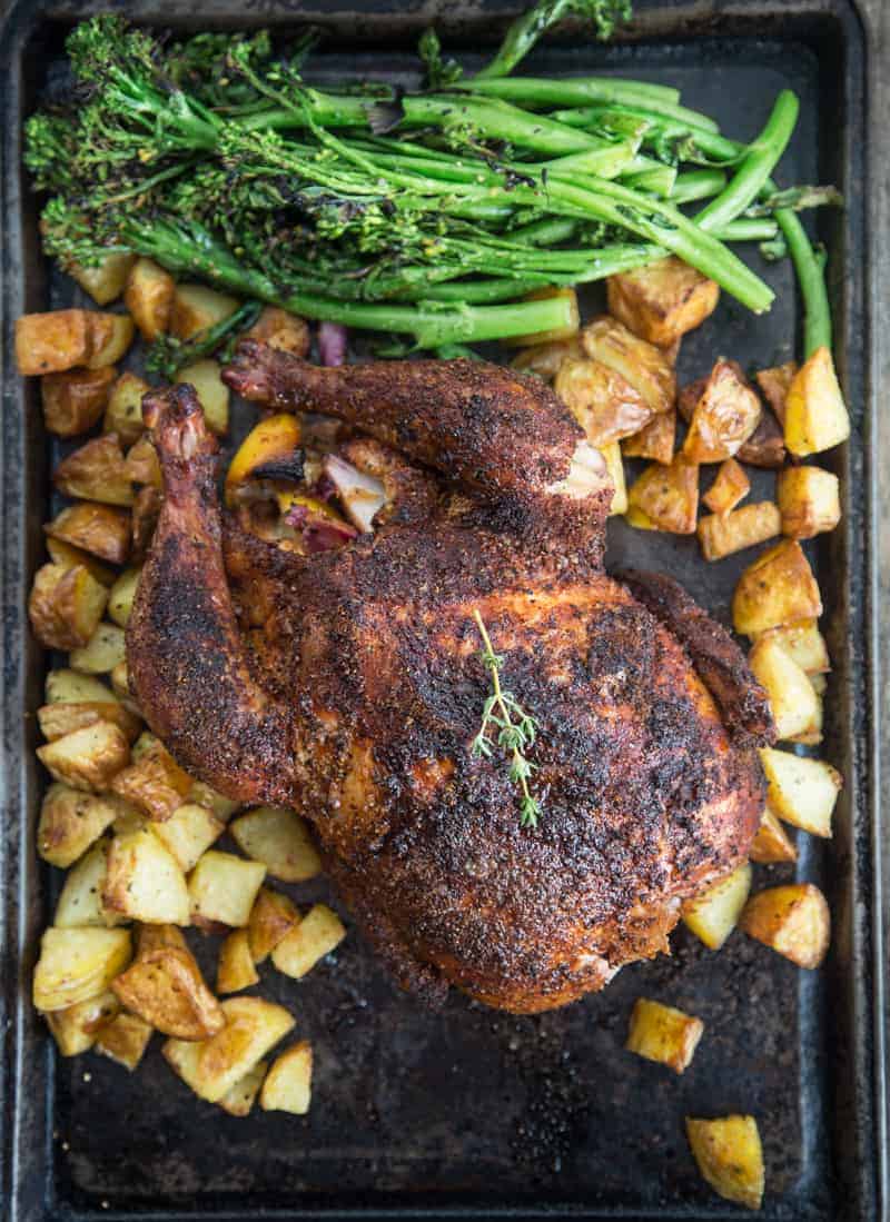 Smoked Whole Roaster Chicken over roasted potatoes.