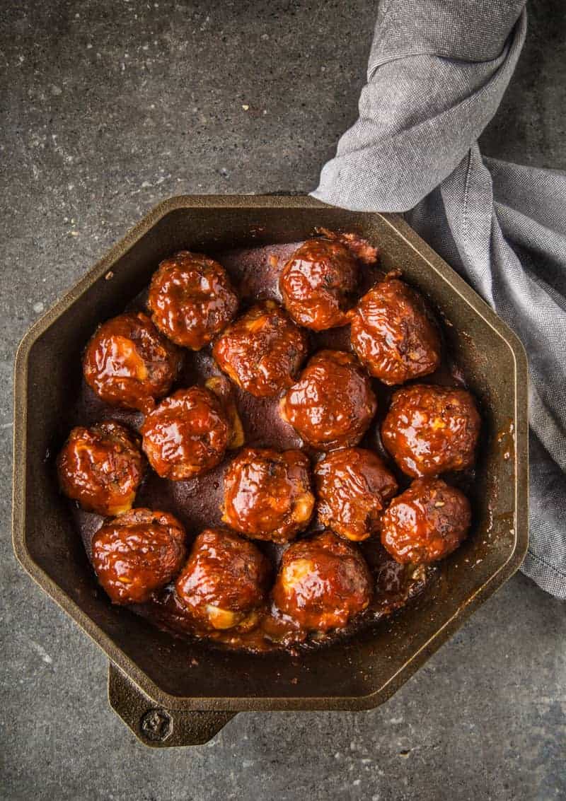 Cheese Stuffed Smoked Meatballs with BBQ Glaze in a FINEX cast iron pan