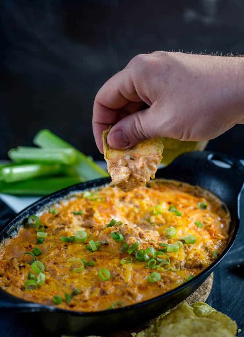 Dipping a chip in Buffalo chicken dip.