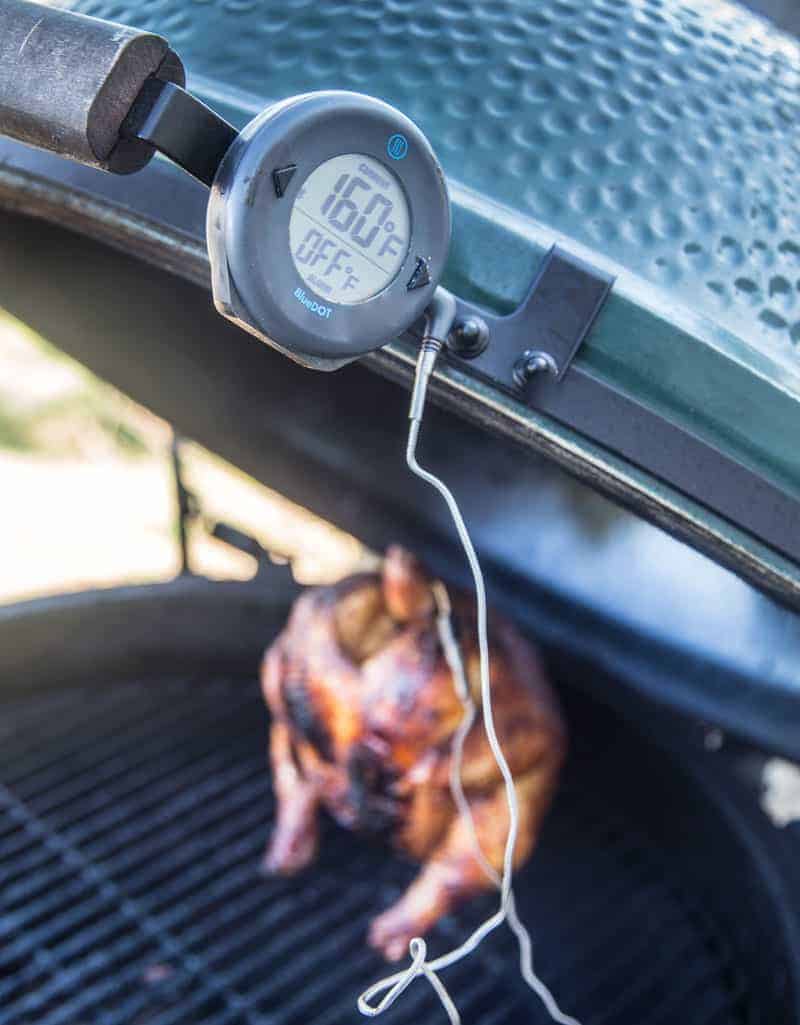 A closeup of a BlueDot digital thermometer attached to a Big Green Egg grill