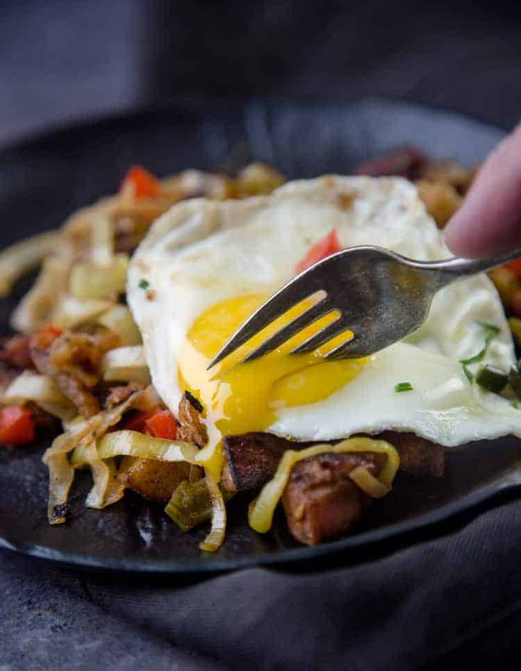 Cutting into a runny fried egg