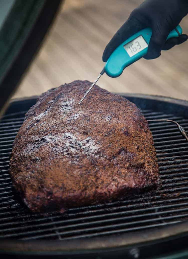 Taking temperature of brisket for burnt ends.