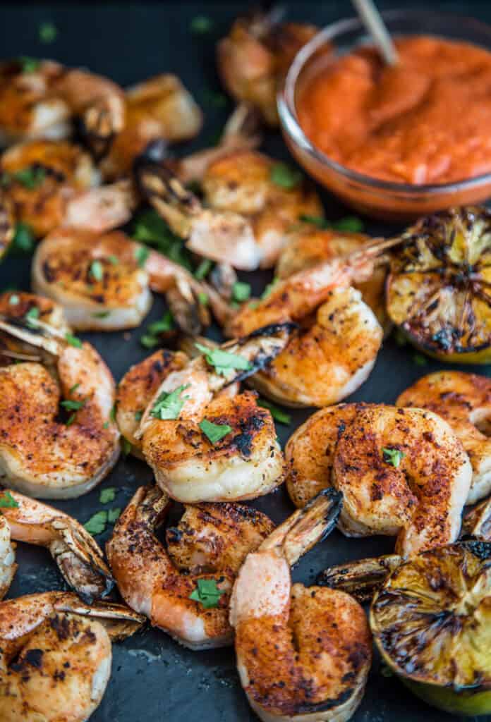 Grilled Shrimp Cocktail served on a platter with spicy cocktail sauce. 