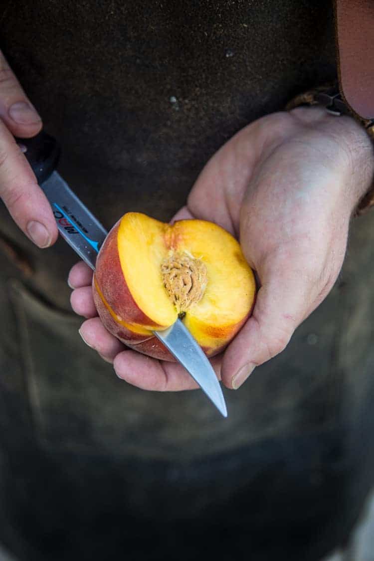A peach with a slice removed. 