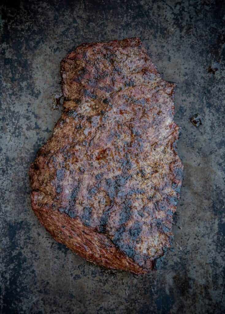 Bavette steak resting on a sheet pan. 