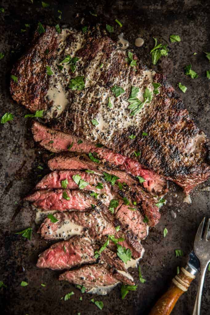 Grilled Bavette Steak sliced thin on a cutting board