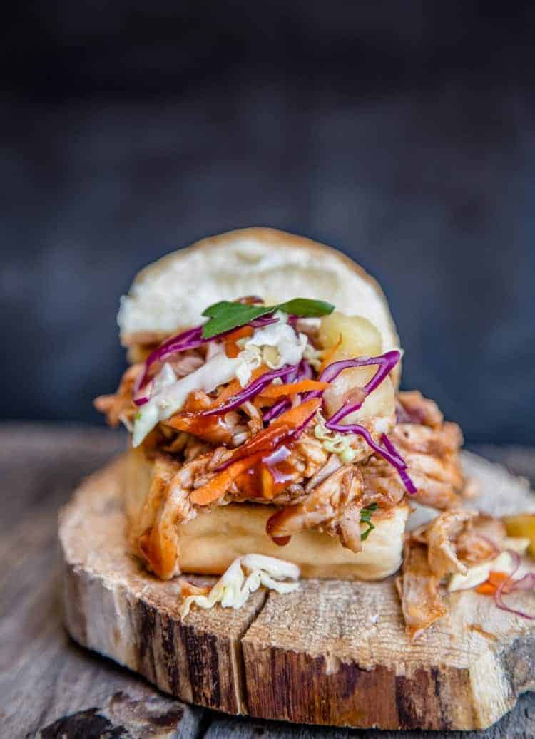 A pulled BBQ chicken slider using a Hawaiian style bun