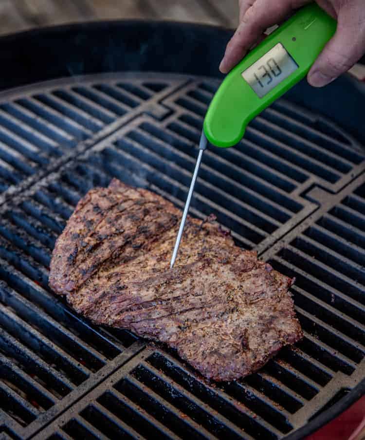 Taking the temperature of a steak with a Thermoworks digital thermometer.