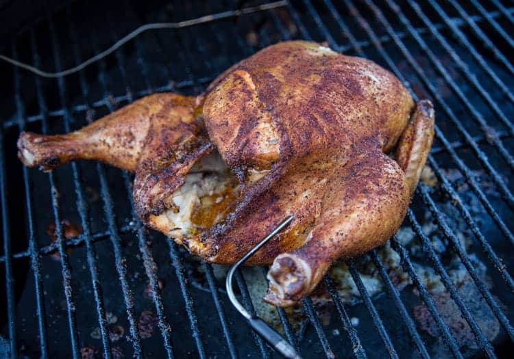 A whole roaster chicken cooked on a smoker
